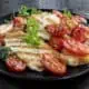 Halloumi cheese, grilled, with roasted cherry tomatoes and herbs.