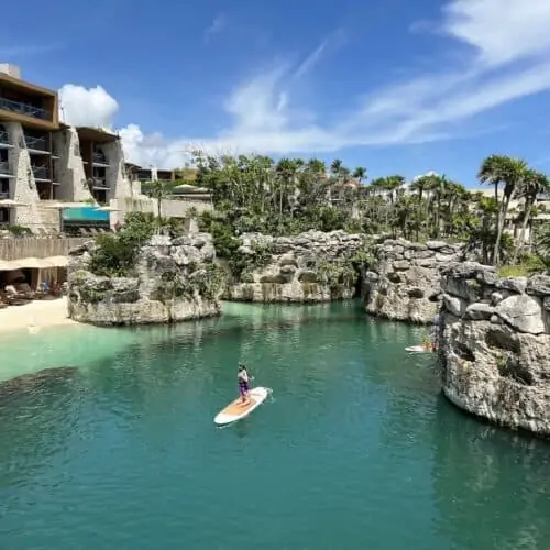 Woman paddleboarding at Hotel Xcaret Arte in Mexico.