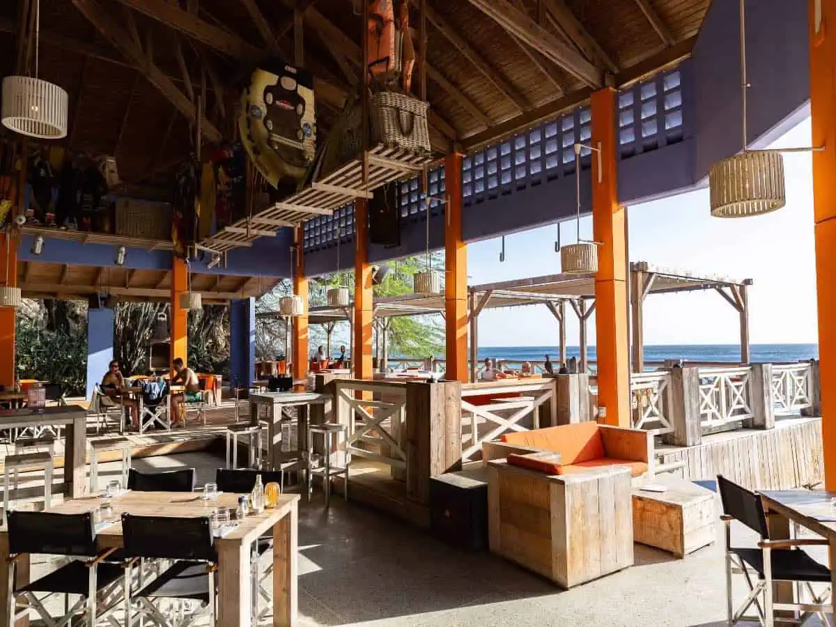 Tables in restaurant overlooking ocean.