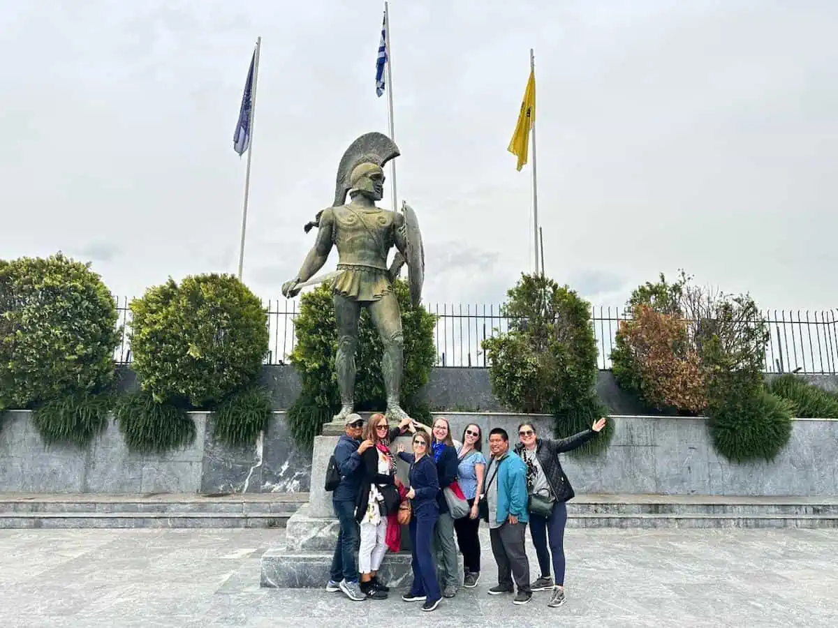 Group of people touching the toe of Leonidas, a top things to do in Sparta.  