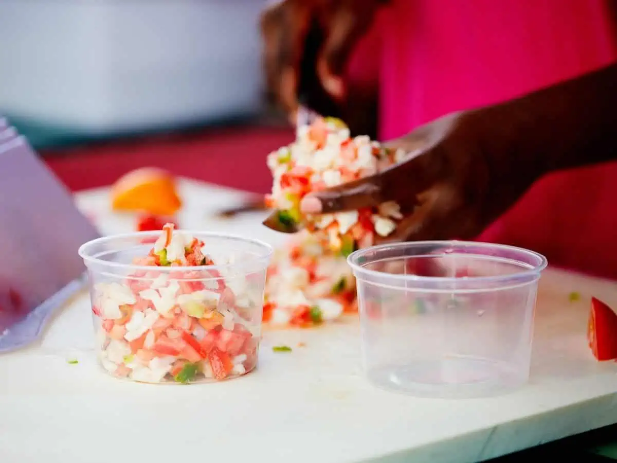 A woman making conch salad in Freeport, Bahamas. 