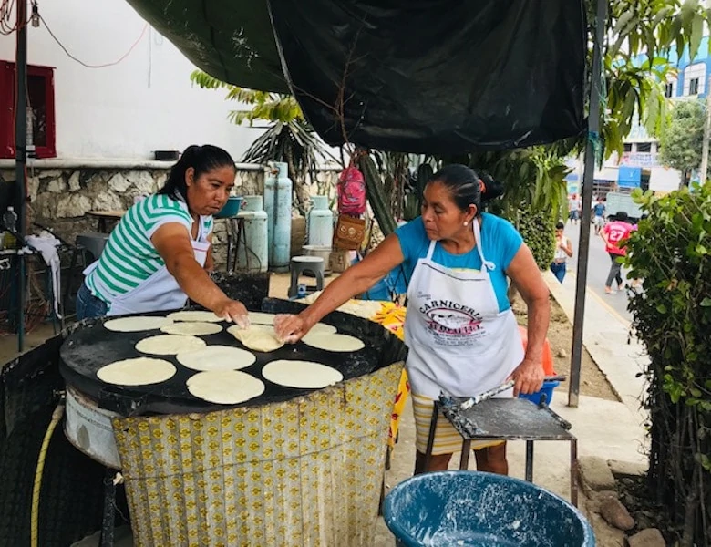 Women making tortillas de maize, a top food in Puerto Escondido Mexico. 
