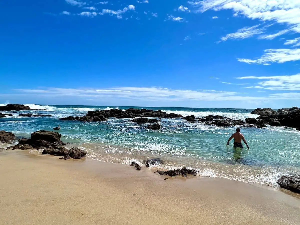 Man in a tidal pool at Agua Blanca beach in Oaxaca.  