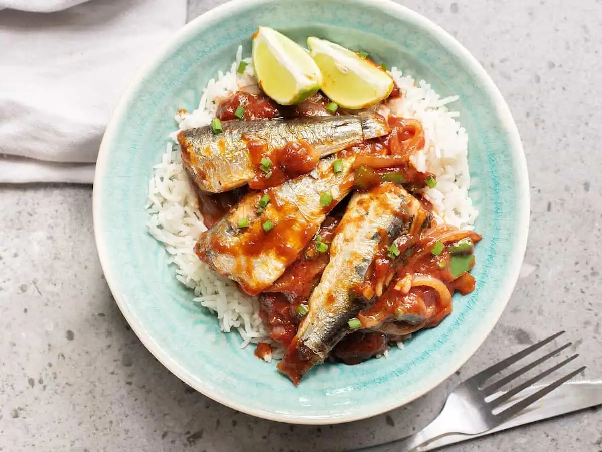 Canned sardines in Tomato sauce in a pale blue bowl. 