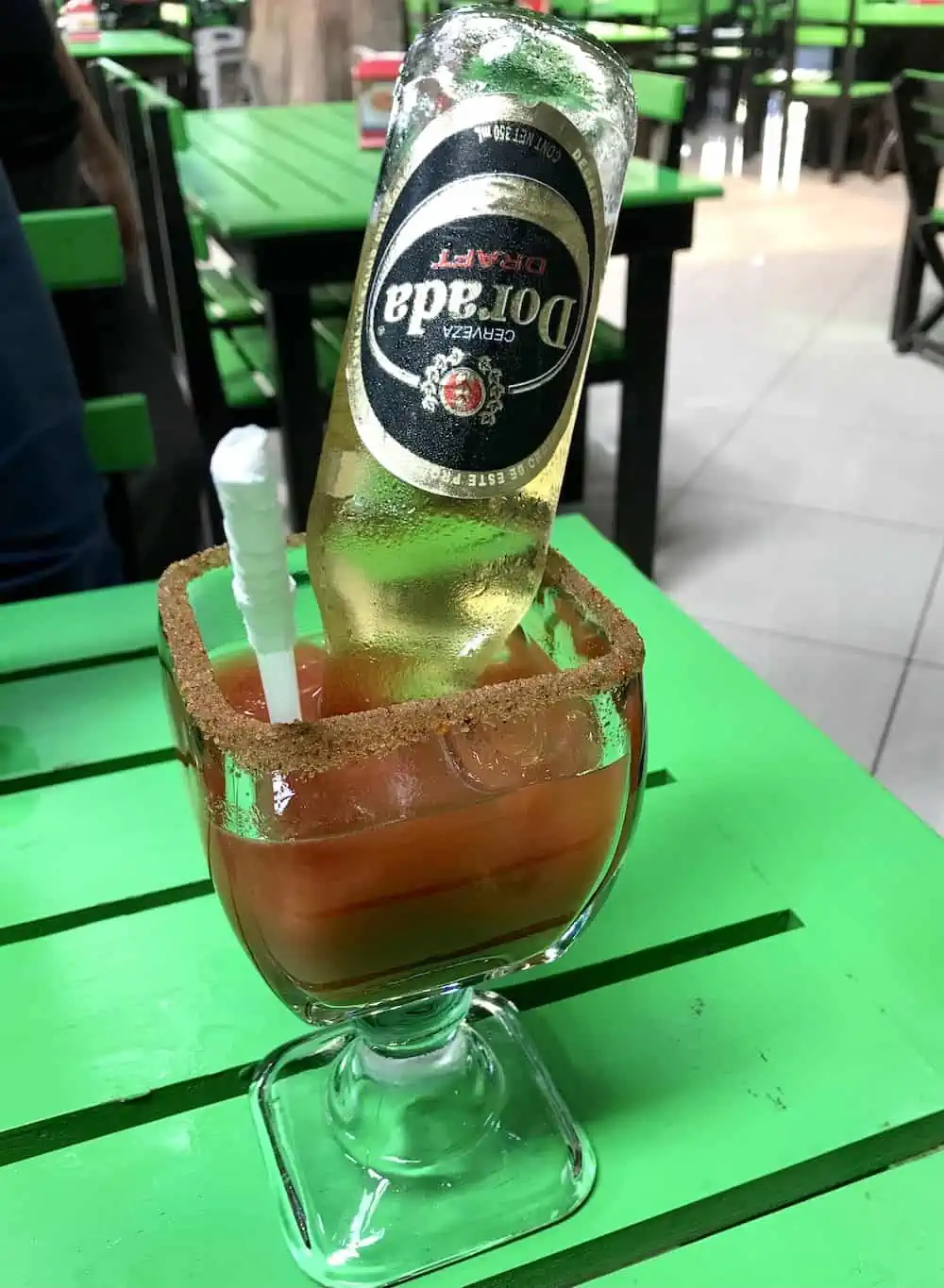 A unique way of serving  Guatemalan  Michelada is with the bottle of beer inverted in the glass. 