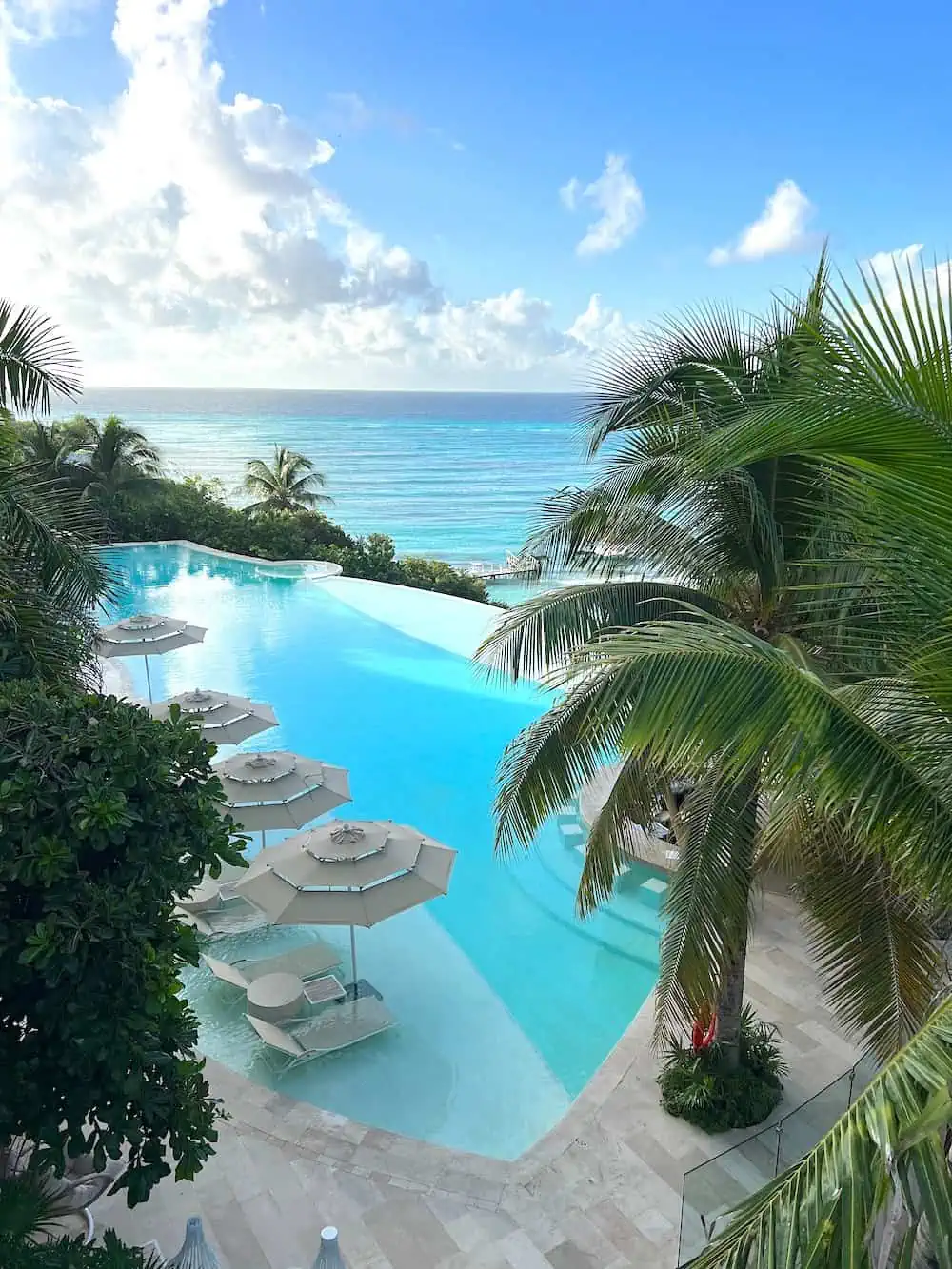Morning view of the main pool and Caribbean Sea from Suite 1116 at Impression Isla Mujeres by Secrets. (Credit: Michele Peterson). 