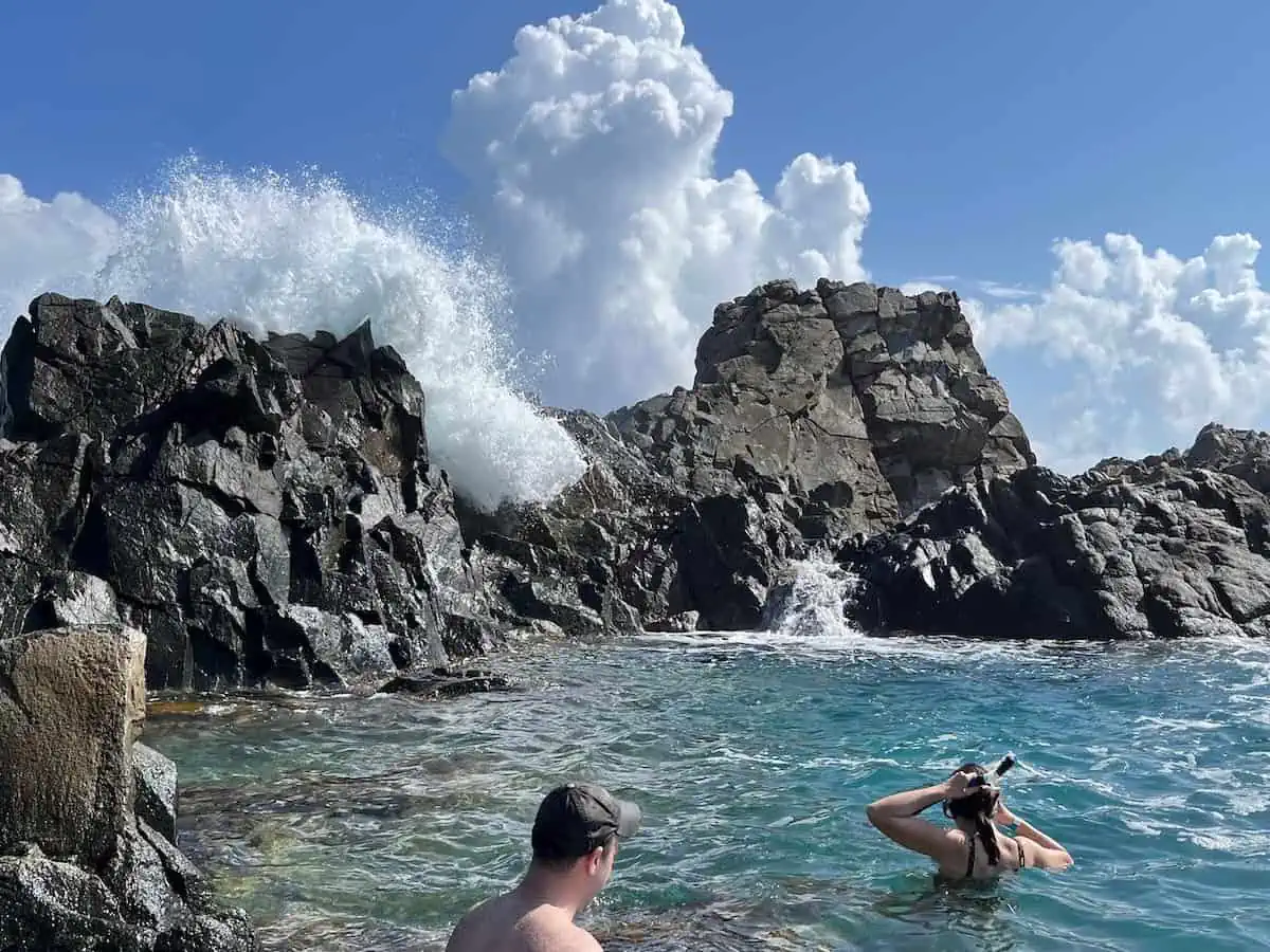 Two people in Conchi (the natural pool) in Aruba. Credit: Aruba Nature Adventures