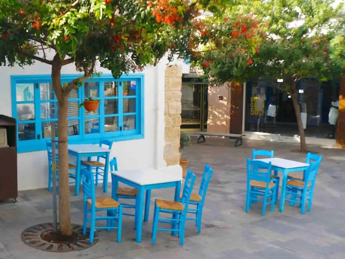 Blue chairs and table at a coffee shop in Old Town Paphos. oo