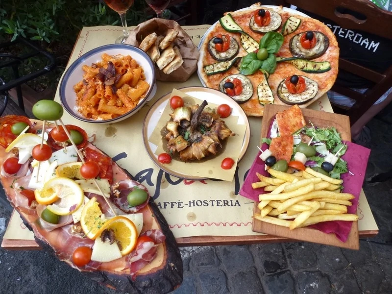 An array of delicious appetizers and pasta on an Eating Europe Food Tour in Rome.