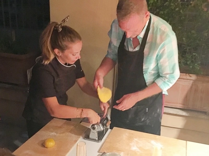Two people taking a pasta class in  Rome.