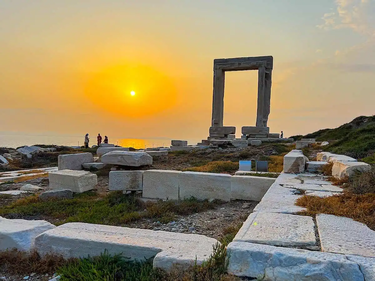 Made of white marble, the Portara Gateway on an islet in Naxos harbour at sunset.