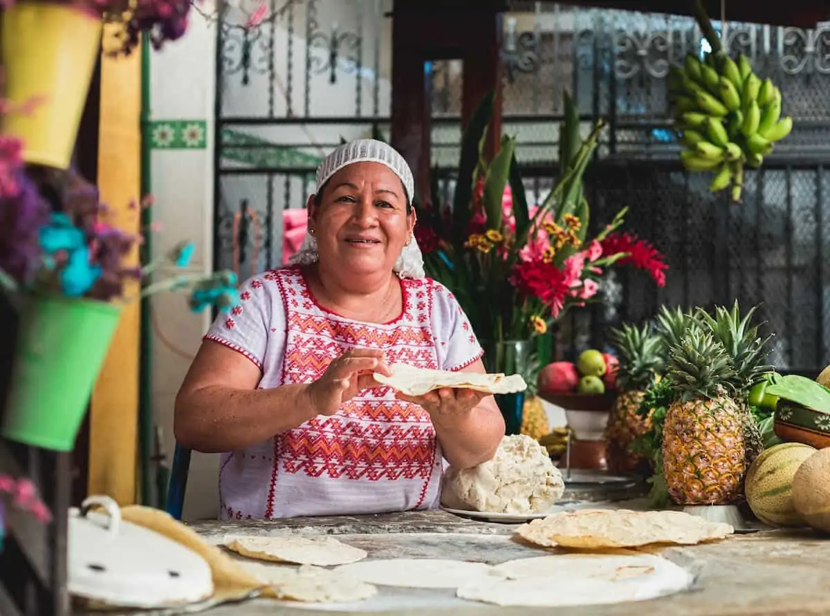 Woman making tortillas on a comal in Puerto Escondido Mexico.