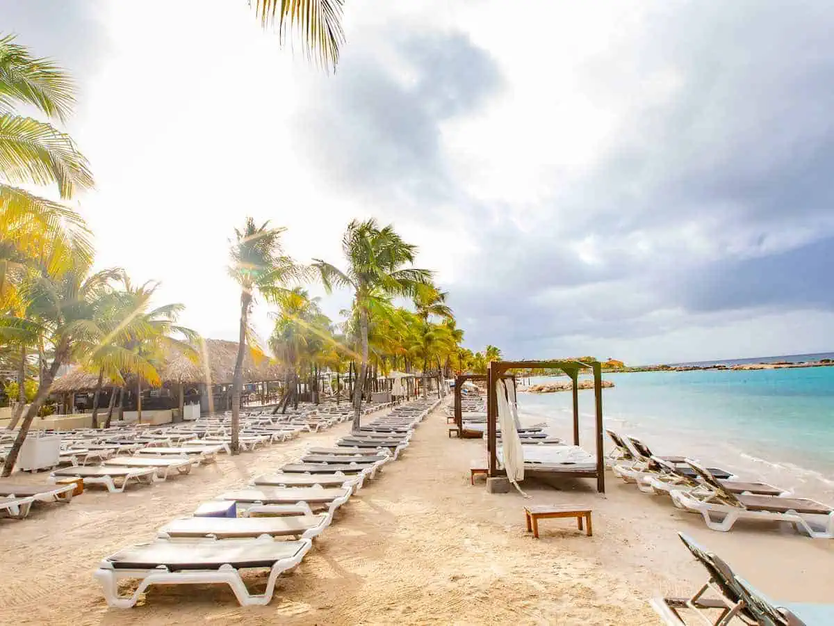 Lounge chairs on the sand at Rileks Beach Bar in Curacao's Mambo Beach.  