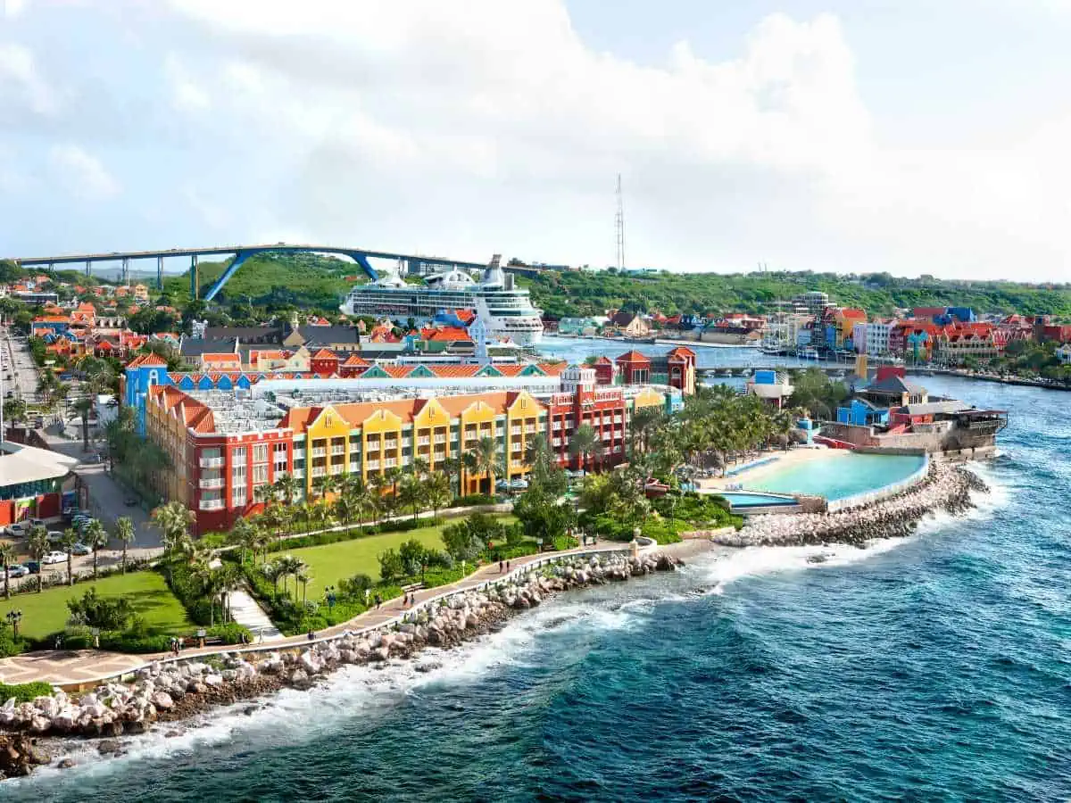 Renaissance Wind Creek Curaçao Resort with colorful buildings and ocean.