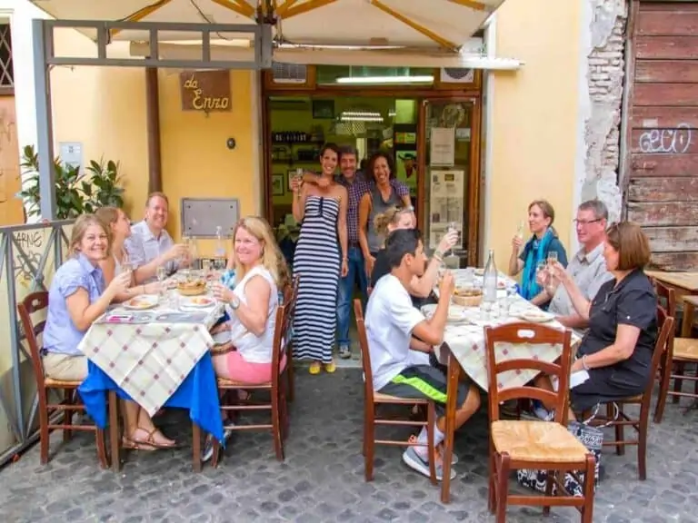 Group of people dining at Da Enzo Restaurant in Rome.