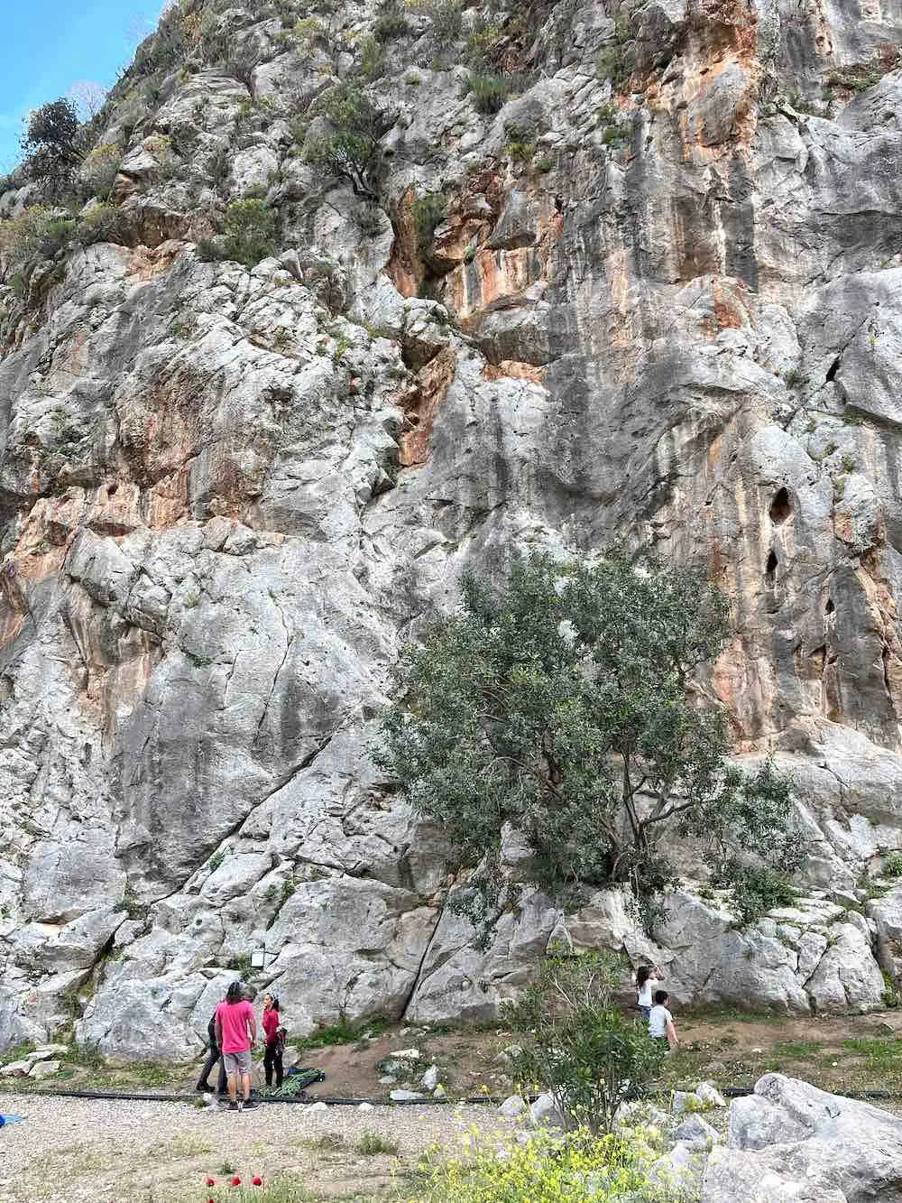 People at the base of rock. 