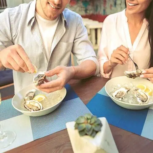 Couple enjoying oysters.