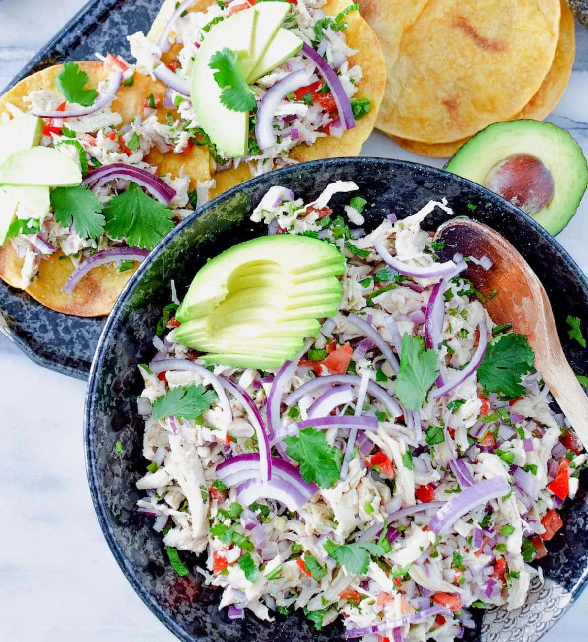 Chicken salpicon de pollo in a bowl and on tostadas.