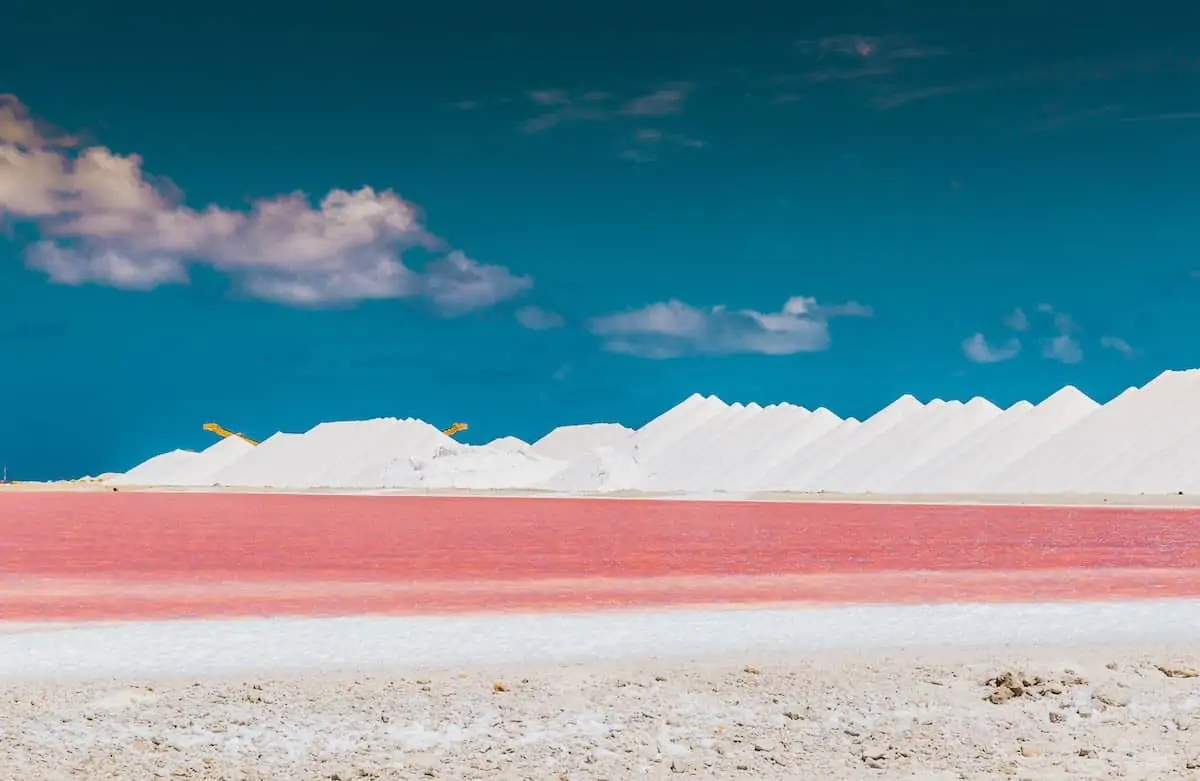 Pink salt pans of Bonaire with mountains of salt.