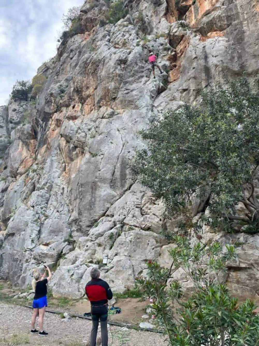 People scaling the rock climbing. 