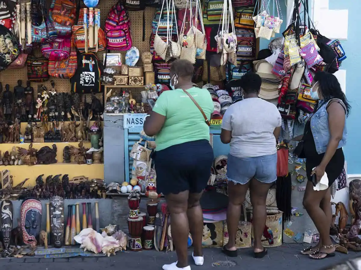 Three women shopping in Straw Market in Nassau Bahamas.