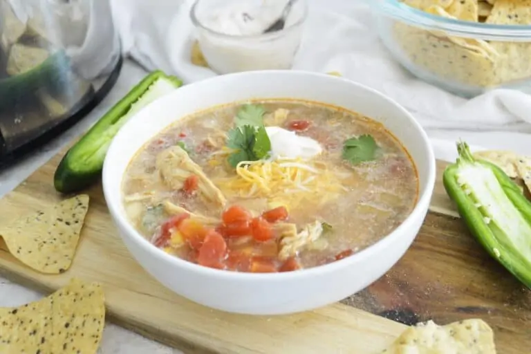 Bowl of Slow Cooker Chipotle Chicken soup on a wooden board.