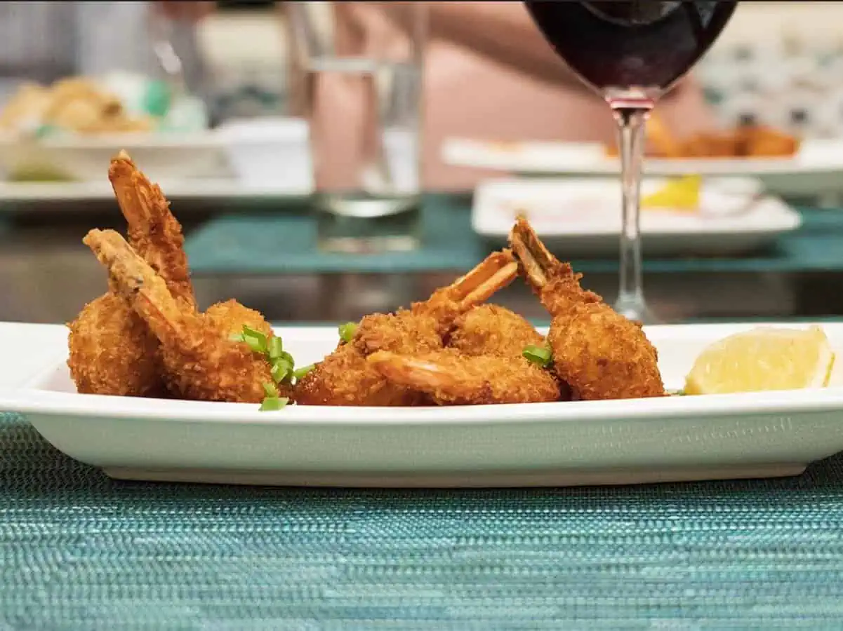 Shrimp Tempura on a white plate and a blue tablemat at Sandbar, a popular Anguilla restaurant. 