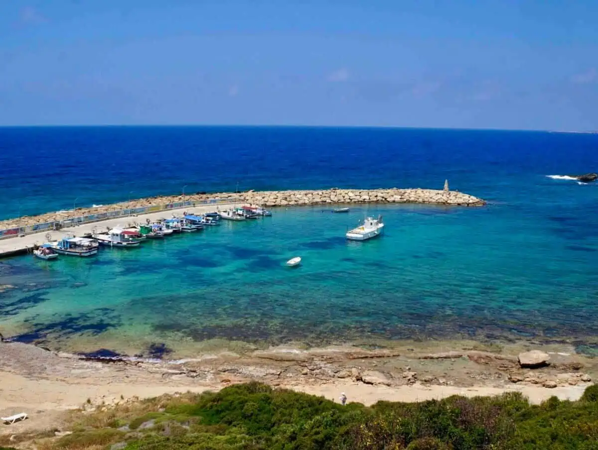 Boat in the water off the beach at St. George Harbour in Cyprus. a