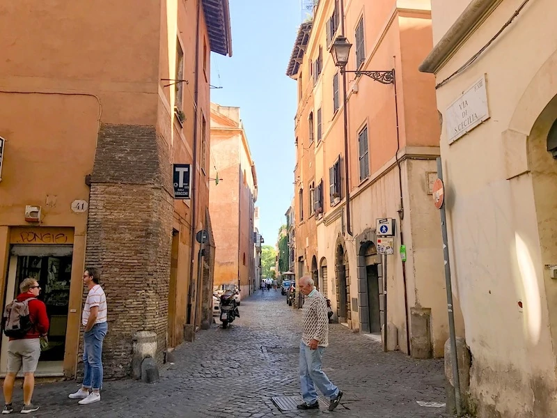 People walking on the narrow streets in Trastevere Rome.