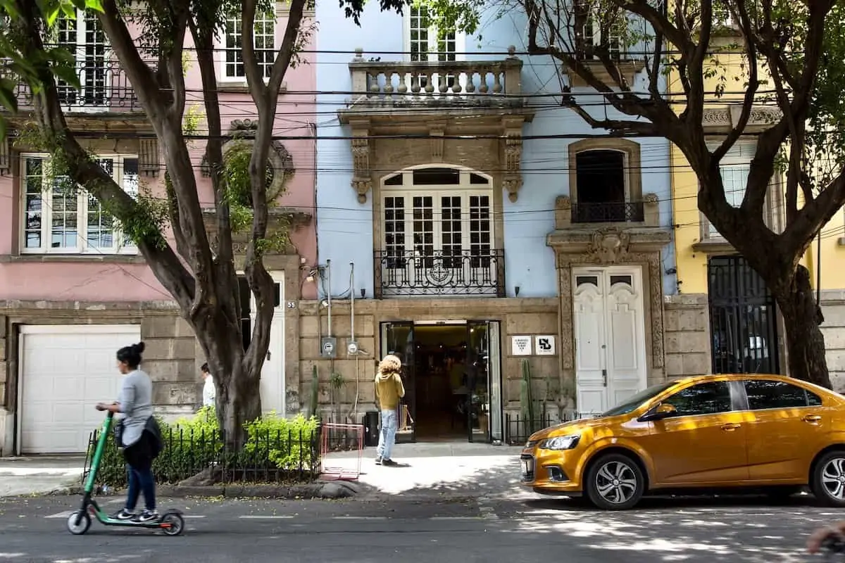 People on a leafy street in Roma Norte in Mexico City.