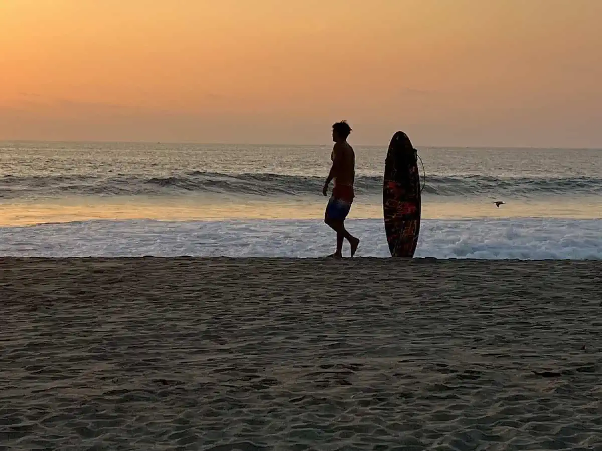 Young man with a surf board in Guatemala.