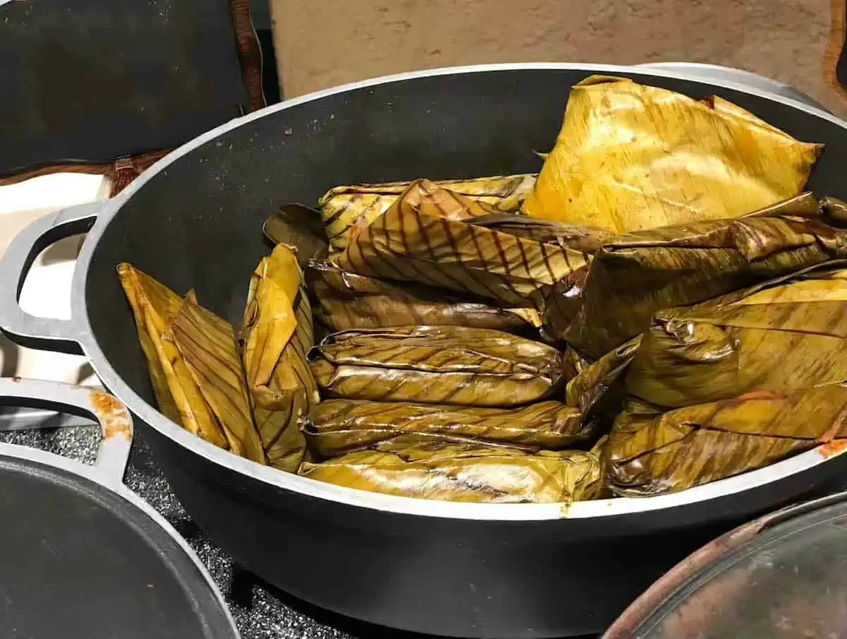 Tamalitos de chipilin in a metal serving dish in Guatemala.