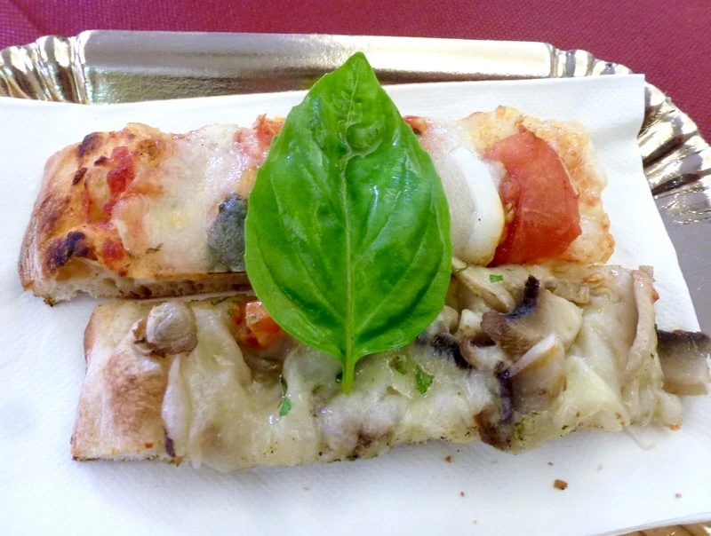 Two pieces of pizza to sample on the Taste of Testaccio food tour. 