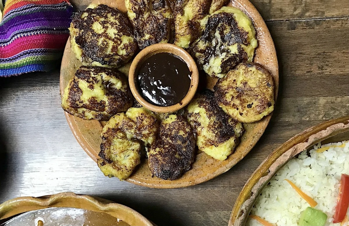 The famous Guatemalan dish of rellenitos de platano in a clay dish. 