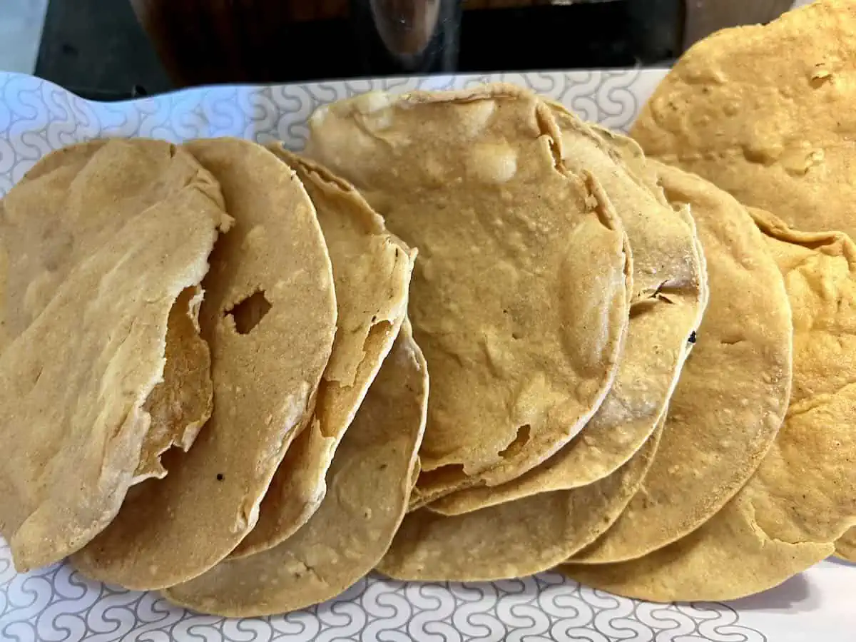 A row of tostadas waiting for toppings.