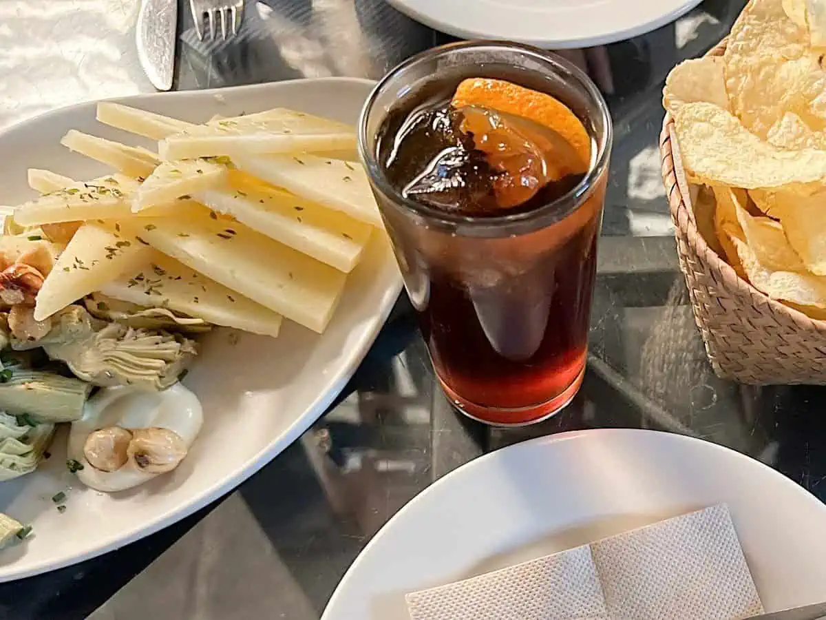 Housemade vermouth served with an orange slice at Bastaix Bar. 