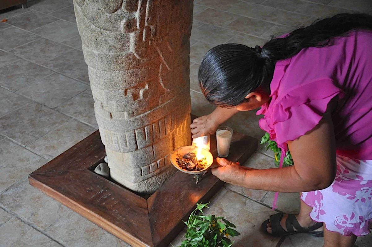 Woman making an offering in Tututepec, Mexico.