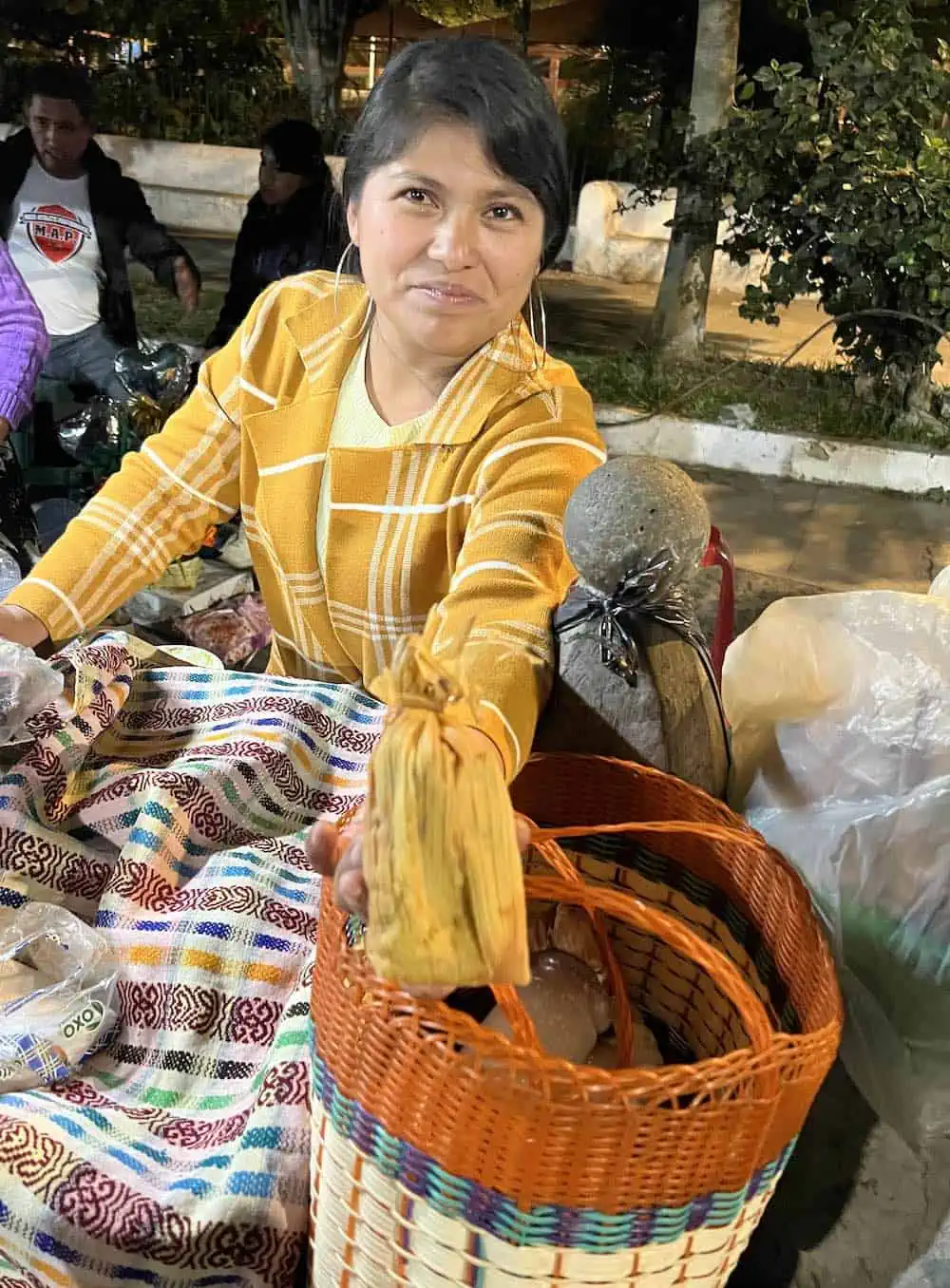 Young woman selling chuchitos in San Pedro Las Huertas near Antigua.